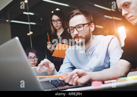 Business people brainstorm concept. Generic design notebook on wood table, papers, documents. Team of businessmen are thinking over a new startup at t Stock Photo