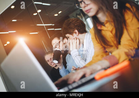 Coworking team brainstorming in modern office. Working atmosphere in meeting room. oung creative managers team working with new startup project in mod Stock Photo