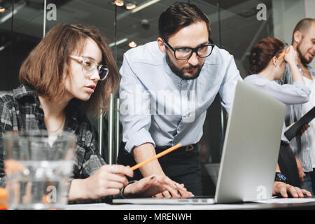Brainstorming new startup business team coworking workers. Work in modern loft space and uses digital gadgets and laptops. Concept of teamwork busines Stock Photo