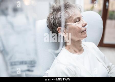 Senior woman with nasal cannula and IV bag. Stock Photo