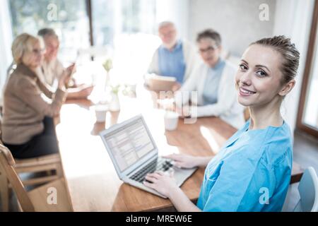 Care worker with laptop in care home, portrait. Stock Photo