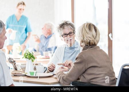 Senior women talking in care home. Stock Photo