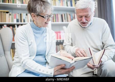 Senior couple reading books. Stock Photo