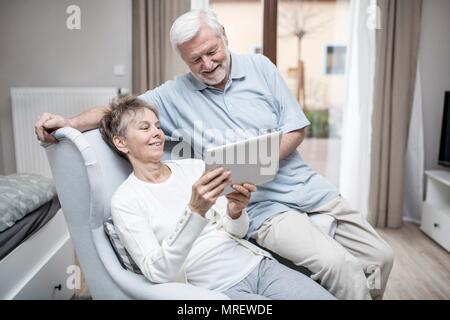 Senior couple in hospital room looking at digital tablet. Stock Photo
