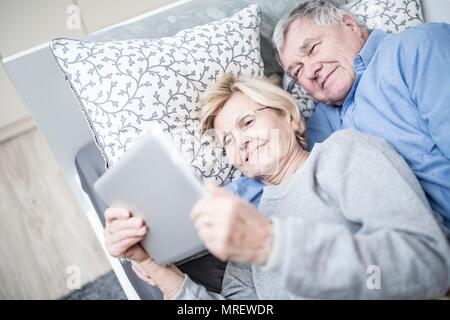Senior couple looking at digital tablet. Stock Photo