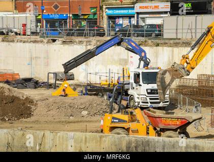 Dumper truck and lorry at work on the site of a new office development in Pontypridd town centre Stock Photo