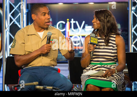 Gunnery Sgt. Justin A. Hauser, enlisted conductor of Marine Corps Band New Orleans, talks with Sharon Barnes-Waters, co-host of CityViews on 1010 Wins, in New York, June 13, 2017. Hauser and members of the band performed several songs live to promote the Marine Corps Reserve Centennial concerts June 14-16, in multiple locations across the city. Stock Photo