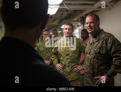 Commanding General of 3d Marine Aircraft Wing, Maj. Gen. Mark R. Wise, right, and Chief of the Australian Army, Lieutenant General Angus Campbell, second from right, speak with crew aboard the amphibious assault ship USS America (LHA 6) off the coast of Southern Calif., June 12, 2017. Maj. Gen. Wise and Lieutenant General Campbell flew with VMM-363 to visit the amphibious assault ship USS America (LHA 6) to receive a tour and view the capabilities of the ship. (U.S. Marine Corps photo by Sgt. Tia Dufour/Released) Stock Photo