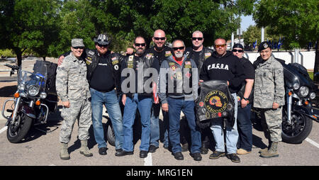 Members of the Combat Veterans Motorcycle Association pose with Team Kirtland airmen at the New Mexico Veterans Memorial, May 30, 2017. The veterans rode over to the New Mexico Veterans Memorial, where they had a chance to remember the fallen with Kirtland airmen and allow the airmen to sign flags that the group was carrying. (U.S. Air Force Photo/Joanne Perkins) Stock Photo