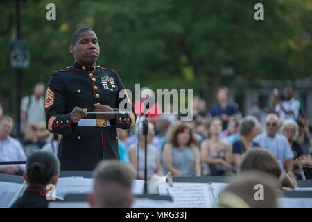 NEW YORK – Gunnery Sgt. Justin A. Hauser, enlisted conductor of Marine Corps Band New Orleans, conducts the Marine Corps Band New Orleans at Washington Square Park in New York, June 14, 2017. The Band’s performance at Washington Square Park was the first of three concerts held throughout New York City, June 14-16. (U.S. Marine Corps photo by Lance Cpl. Niles Lee/Released) Stock Photo