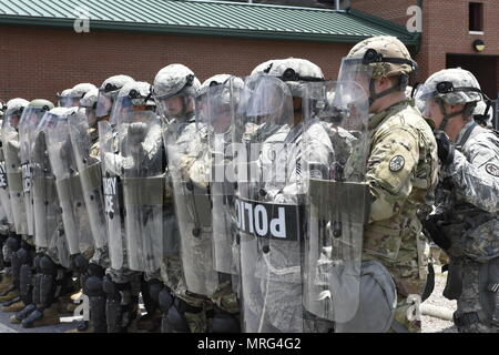 U.S. Air Force Staff Sgt. Brandon Griffin of the 145th Airligt Wing Security Forces, stands in formation with North Carolina National Guard 105th Military Police Battalion for a mock riot as part of Vigilant Catamount at Western Carolina University, Cullowhee North Carolina, June 13, 2017. Vigilant Catamount is a mulitday, multi-agency training exercise ending with simulated riot at Western Carolina University, involving Army National Guard Military police and the 145th Airlift Wing Security Forces. Stock Photo