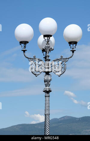 Decorative wrought iron street lamps with four white globes, Florence, Tuscany, Italy, Europe, Stock Photo