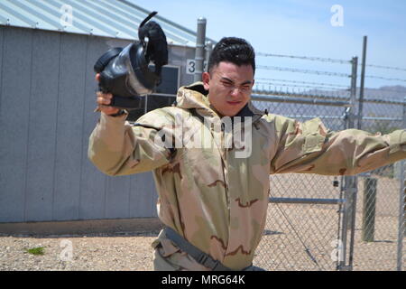 A Soldier squints after exiting the gas chamber during gas chamber training at the Tobin Wells training area at Fort Bliss, Texas, June 6, 2017. Stock Photo