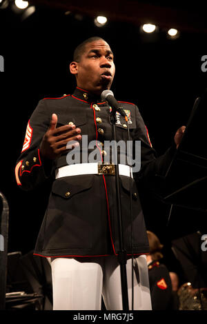 NEW YORK – Gunnery Sgt. Justin A. Hauser, enlisted conductor of Marine Corps Band New Orleans, speaks to the guests of performance at Hunter College in New York, June 15, 2017. The band traveled to New York to celebrate the ending of the Marine Corps Reserve Centennial, marking the end of the hundredth year anniversary of the establishment of the Marine Corps Reserve. (U.S. Marine Corps photo by Lance Cpl. Niles Lee/Released) Stock Photo