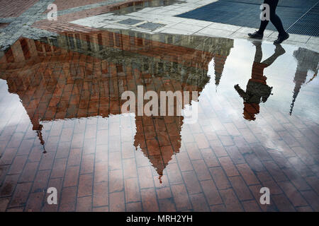 Woman reflection in puddle at Europe Square in Batumi Stock Photo