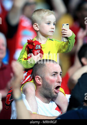 A young Liverpool fan holds a phone in the stands prior to the UEFA Champions League Final at the NSK Olimpiyskiy Stadium, Kiev. Stock Photo