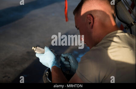 Senior Airman Brandon Murdaugh, a 455th Expeditionary Aircraft Maintenance Squadron crew chief, inspects a constant speed drive filter before installing it on an F-16 Fighting Falcon at Bagram Airfield, Afghanistan, June 16, 2017. CSDs are mainly used on airliner and military aircraft jet engines to drive the alternating current electrical generator. (U.S. Air Force photo by Staff Sgt. Benjamin Gonsier) Stock Photo