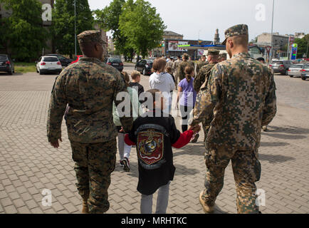 LIEPAJA, Latvia – Latvian Soldiers and U.S. Marines with 2nd Civil Affairs Group, Force Headquarters Group, Marine Forces Reserve come together to successfully host ‘Big Brother Day’ for the local orphanage during Exercise Saber Strike 17 in Liepaja, Latvia, June 9, 2017. The day consists of 11 Marines and 10 Latvian soldiers volunteering their time to take 15 orphans out and show them a day full of activities including go-karts, laser tag, and tours around the town. (U.S. Marine Corps photo by Cpl. Devan Alonzo Barnett/Released) Stock Photo