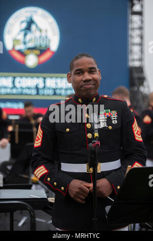 NEW YORK – Gunnery Sgt. Justin A. Hauser, enlisted conductor of Marine Corps Band New Orleans, speaks to the guests of the performance at Four Freedoms Park on Roosevelt Island in New York, June 16, 2017. The band traveled to New York to celebrate the ending of the Marine Corps Reserve Centennial, marking the end of the hundredth year anniversary of the establishment of the Marine Corps Reserve. (U.S. Marine Corps photo by Lance Cpl. Niles Lee/Released) Stock Photo