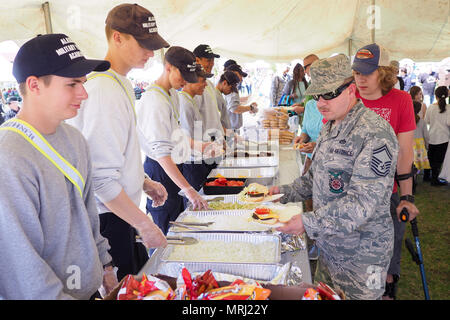 Air Force Senior Master Sgt. John Smith, a 176th Civil Engineer Squadron  firefighter, walks through a food line at the Military Appreciation Week  picnic at the Joint Base Elmendorf-Richardson, Alaska, Buckner Fitness  Center fields June 16, 2017. Several