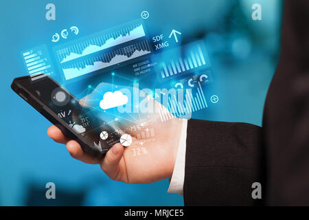 Hand using phone with cloud technology and linked information concept Stock Photo
