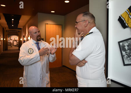170620-N-OS584-189, Pittsburgh PA (June 20, 2018) Vice Admiral Forrest Faison Surgeon General and Chief, Bureau of Medicine and Surgery talks with Jonathan French, MD at University of Pittsburgh at Center for Military Medicine Research (UPMC) Sports Center about way Sports Medicine are helping our Sailors and Marines after coming back from Iraq and Afghanistan with Traumatic Brian Injury. Navy Week focus a variety of outreach assets, equipment and personal on a single city for a week-long series of engagements with key influencers and organizations representing all sectors of the market. Durin Stock Photo