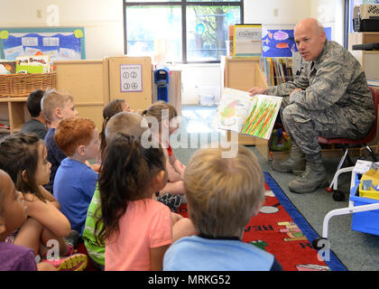 Col. Roman L. Hund (left), installation commander, reads “Mister Seahorse” by Eric Carle to children at the Child Development Center June 12. Hund was invited to read to children by CDC officials. (U.S. Air Force photo by Linda LaBonte Britt) Stock Photo