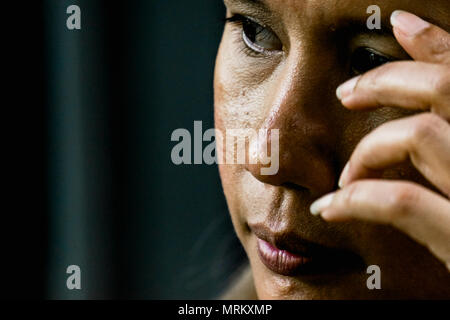 Portrait of Businesswoman with face expression of unhappy feeling and anxiously and sadly at the dark room. Stock Photo