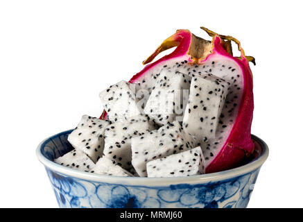 Dragon fruit cut in half in a blue bowl against a white background Stock Photo