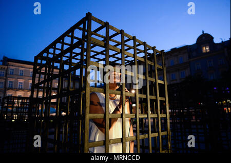 Krakow, Poland. 26th May, 2018. A woman seen inside a cage during a demonstration.Women take part in a ''˜performance' protest inside several cages in the Main Square to express their solidarity for the Women right during Mother Day in Krakow. Credit: Omar Marques/SOPA Images/ZUMA Wire/Alamy Live News Stock Photo