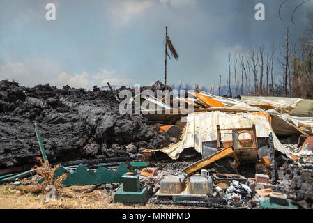 A home in the Leilani Estates crushed by a lava flow from the eruption of the Kilauea volcano May 19, 2018 in Pahoa, Hawaii. Stock Photo