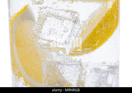 Slices of fresh juicy yellow lemon with ice in water. Stock Photo