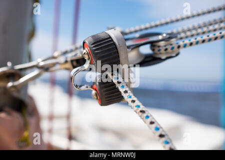 close up on winch and rope of yacht over blue sea Stock Photo
