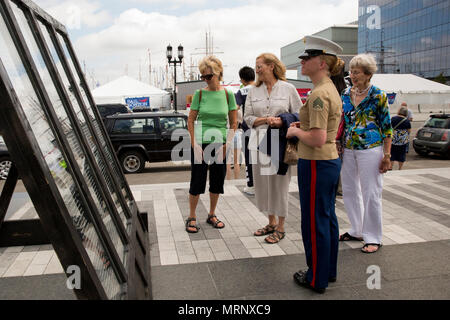 Sgt. Julia Junk views a memorial wall with names of fallen service members during the Fallen Warriors Memorial Ceremony in Boston, Mass., June 18, 2017.  During the ceremony, representatives with the U.S. Navy and U.S. Marine Corps, as well as Naval forces from around the world, laid five wreaths to honor their fallen comrades. In addition, seven yellow roses were laid at the memorial to pay tribute to the seven sailors who lost their lives aboard the USS Fitzgerald (DDG-62) earlier this week. Junk is a field radio operator with Marine Wing Communications Squadron 28, Marine Aircraft Group 14, Stock Photo