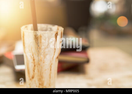 an empty cup of iced mocha coffee on wooden table background. Stock Photo