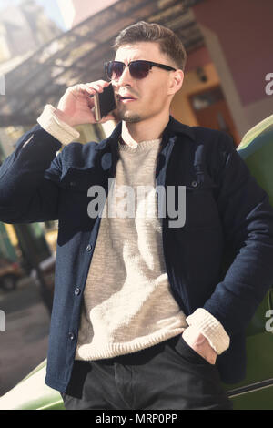 Fashionable guy with sunglasses stay near the car Stock Photo
