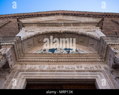 Urbino, Italy - April 30, 2018: Detail of the carved facade of an Italian medieval church. Stock Photo