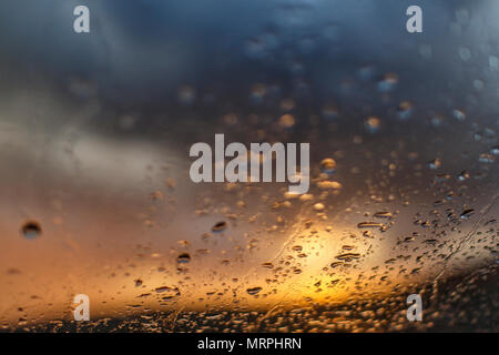sunset on rainy day through window Stock Photo