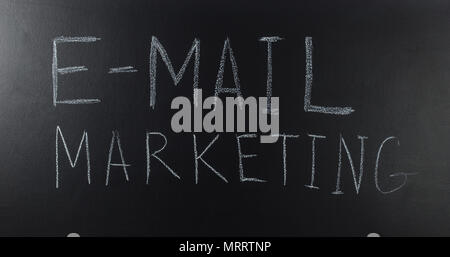 written with a text: E-mail marketing on blackboard Stock Photo