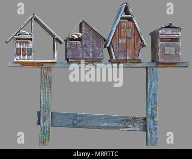 Mini wooden house mailboxes on a bench top, with isolated gray background and clipping path. Stock Photo