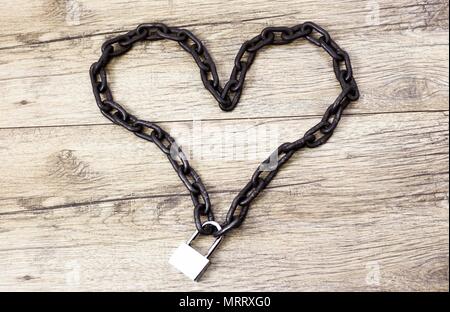 Rusty chain heart shape on the lock Stock Photo