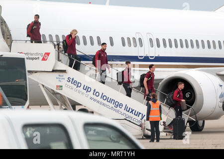 Liverpool players get off the plane at John Lennon Airport after defeat in the UEFA Champions League Final against Real Madrid in Kiev. Stock Photo