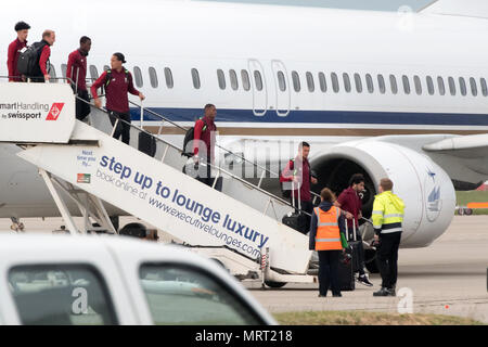 Liverpool players including Mo Salah (right) gets off the plane at John Lennon Airport after defeat in the UEFA Champions League Final against Real Madrid in Kiev. Stock Photo