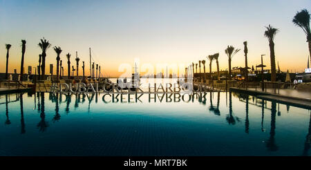 Dubai, United Arab Emirates - December 13, 2017: Dubai Creek harbor romantic sunset scene reflected in the water Stock Photo