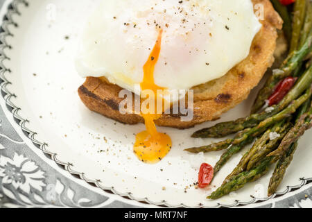 Poached Egg on Toasted Bread With Green Asparagus and Chili Peppers Stock Photo