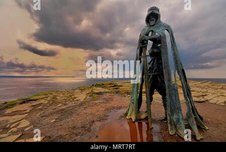 Tintagel, Cornwall, UK - April 10 2018: The King Arthur statue Gallos by Rubin Eynon stands on a rocky headland on the Atlantic coast of Cornwall Stock Photo