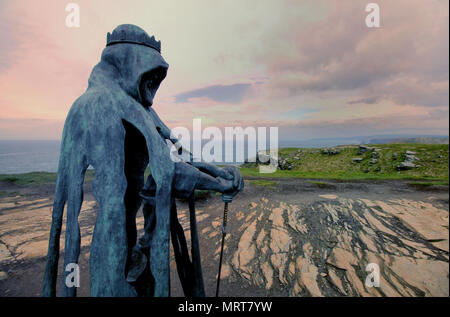 Tintagel, Cornwall, UK - April 10 2018: The King Arthur statue Gallos by Rubin Eynon stands on a rocky headland on the Atlantic coast of Cornwall Stock Photo