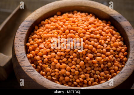 Healthy Organic Red Lentils in Bowl on Dark Wooden Table Stock Photo