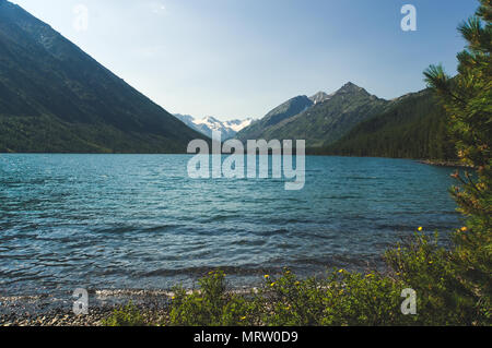 Multinskoe lake with crystal clear fresh water in the Altai mountains. Stock Photo