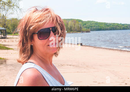 portrait retired woman on vacation at the beach Maskinonge Lake St-Gabriel-de-Brandon Quebec Canada Stock Photo